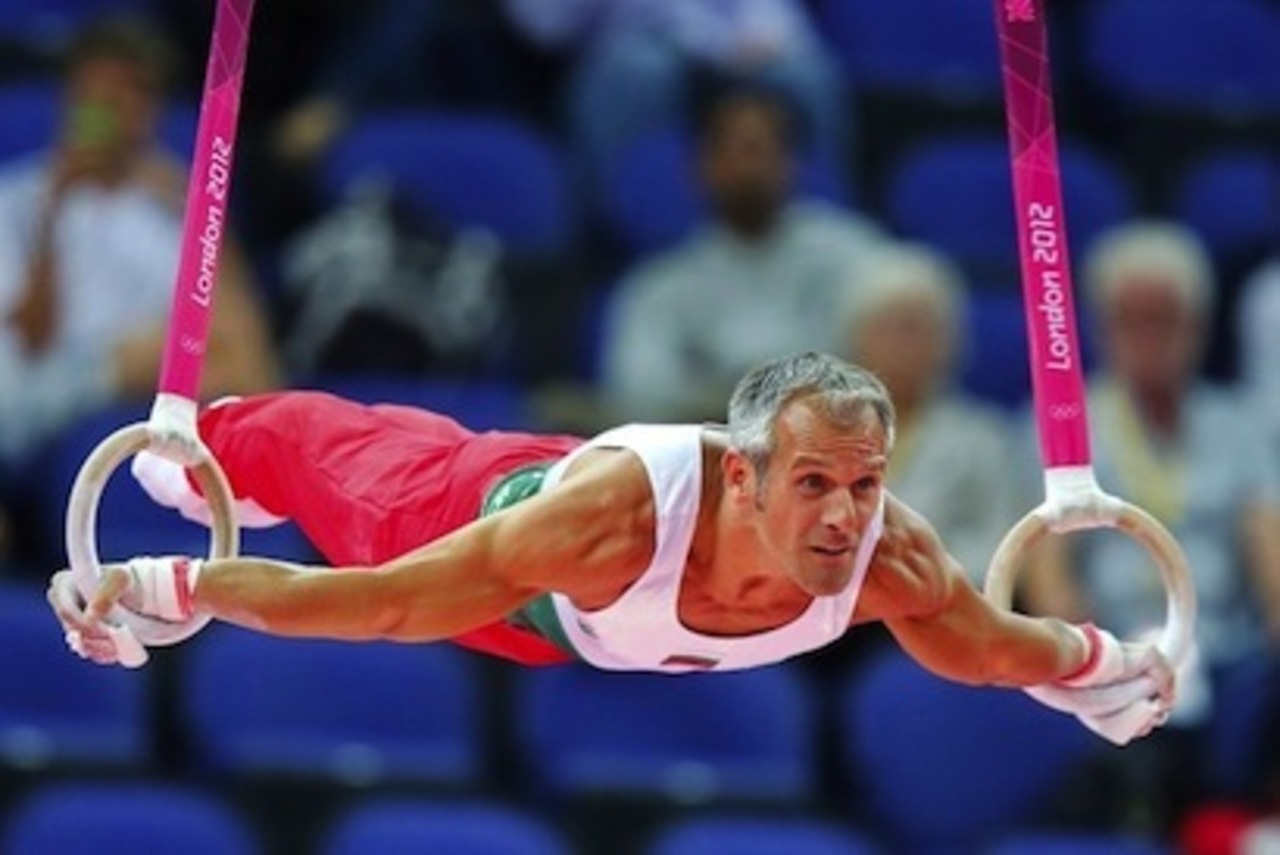 Jordan Jovtchev of Bulgaria warms up on the rings during the men's gymnastics qualification in the North Greenwich Arena during the London 2012 Olympic Games